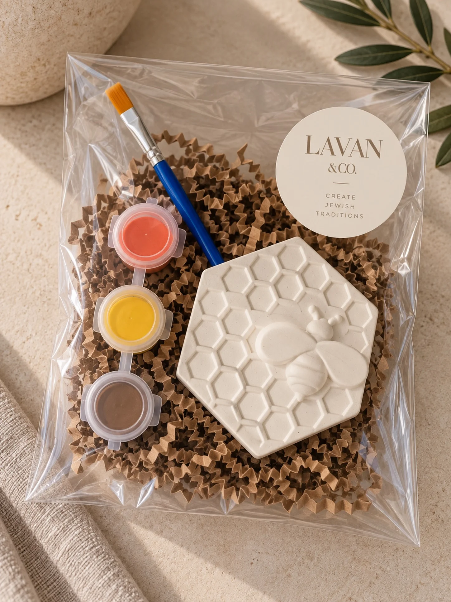 Lavan & Co. craft kit with a bee and honeycomb painting piece, three paint pots, and a paintbrush